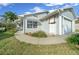 Well-maintained home with light-colored siding, an attached garage, and manicured lawn at 7 Ginger Cir, Leesburg, FL 34748