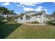 Charming single-story home with an attached garage and mature tropical landscaping at 7 Ginger Cir, Leesburg, FL 34748