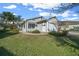 House exterior with light gray siding and landscaped yard at 7 Ginger Cir, Leesburg, FL 34748