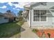 Side view of a home with an attached carport and mature landscaping at 7 Ginger Cir, Leesburg, FL 34748