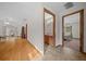 Hallway with wood flooring, leading to bathroom and bedroom at 7 Ginger Cir, Leesburg, FL 34748