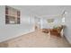 Sunlit living room with tile flooring, wicker furniture and sliding glass door to the outside at 7 Ginger Cir, Leesburg, FL 34748