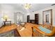 Living room featuring wood floors, wicker furniture, and built-in shelves at 7 Ginger Cir, Leesburg, FL 34748