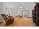 Bright living room with wood floors, wicker furniture, and sliding glass doors to the outside at 7 Ginger Cir, Leesburg, FL 34748