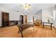 Living room with hardwood floors, ceiling fan, and built-in shelving at 7 Ginger Cir, Leesburg, FL 34748