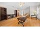 Living room with hardwood floors, ceiling fan, and built-in shelving at 7 Ginger Cir, Leesburg, FL 34748