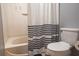 Clean bathroom with a shower/tub combo and toilet at 702 Skyridge Rd, Clermont, FL 34711