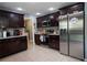 Modern kitchen with stainless steel appliances and dark wood cabinets at 702 Skyridge Rd, Clermont, FL 34711