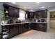 Modern kitchen with dark wood cabinets and stainless steel appliances at 702 Skyridge Rd, Clermont, FL 34711