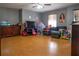 Spacious living room with hardwood floors and large TV at 702 Skyridge Rd, Clermont, FL 34711