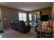 Cozy living room with leather seating and a large window at 702 Skyridge Rd, Clermont, FL 34711