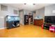 Living room featuring hardwood floors, a large fish tank, and a TV at 702 Skyridge Rd, Clermont, FL 34711