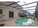 Screened-in pool with patio furniture and surrounding landscaping at 702 Skyridge Rd, Clermont, FL 34711