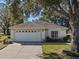 House with white exterior, attached garage, and spacious yard at 7023 Arcadian Ct, Mount Dora, FL 32757