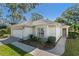 White one-story house with attached garage and landscaped yard at 7023 Arcadian Ct, Mount Dora, FL 32757