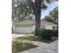 One-story home with white exterior, attached garage, and landscaping at 7023 Arcadian Ct, Mount Dora, FL 32757