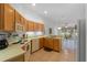 Kitchen with wood cabinets, breakfast bar, and view of backyard at 7023 Arcadian Ct, Mount Dora, FL 32757