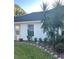 Landscaped front yard with plants and trees at 7023 Arcadian Ct, Mount Dora, FL 32757