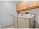 Laundry room with washer, dryer and cabinets at 7023 Arcadian Ct, Mount Dora, FL 32757