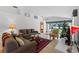 Bright living room with comfy sofas, a Christmas tree, and tiled floors at 7023 Arcadian Ct, Mount Dora, FL 32757