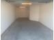 Spacious garage with painted concrete floor at 7268 Annison Ter, The Villages, FL 32163