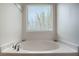 Relaxing bathtub with a window offering natural light at 742 Franklin Ct, Haines City, FL 33844