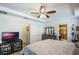 Spacious bedroom with a large bed, dresser, and TV at 742 Franklin Ct, Haines City, FL 33844