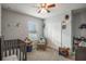 Charming bedroom with a crib, rocking chair, and books at 742 Franklin Ct, Haines City, FL 33844