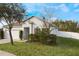 Two-story house with white exterior, landscaping, and a fenced backyard at 742 Franklin Ct, Haines City, FL 33844