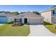 One-story house with a two-car garage and landscaping, aerial view at 8661 Triumph Cir, Wildwood, FL 34785