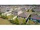 Aerial view of houses with backyard and surrounding neighborhood at 8661 Triumph Cir, Wildwood, FL 34785