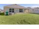 Spacious backyard with grassy lawn and privacy fence at 8661 Triumph Cir, Wildwood, FL 34785