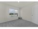 Simple bedroom with grey carpet and window with blinds at 8661 Triumph Cir, Wildwood, FL 34785