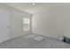 Simple bedroom with grey carpet and window with blinds at 8661 Triumph Cir, Wildwood, FL 34785