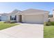 One-story house with a front yard and driveway at 8661 Triumph Cir, Wildwood, FL 34785