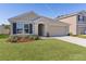 One-story house with a front yard and driveway at 8661 Triumph Cir, Wildwood, FL 34785