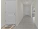 Light and bright hallway with tile flooring at 8661 Triumph Cir, Wildwood, FL 34785