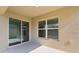 Covered patio with sliding glass door and window at 8661 Triumph Cir, Wildwood, FL 34785