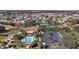 Aerial view of community clubhouse, swimming pool, tennis courts, and parking area at 878 Oviedo Rd, The Villages, FL 32159