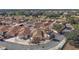 Aerial view of a residential neighborhood highlighting the proximity to the community golf course and pond at 878 Oviedo Rd, The Villages, FL 32159