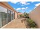 A cozy backyard featuring a concrete patio, gravel accents, and lush greenery, perfect for relaxing outdoors at 878 Oviedo Rd, The Villages, FL 32159