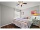 Bedroom with wood floors, ceiling fan, and coastal style decor at 878 Oviedo Rd, The Villages, FL 32159