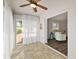 Bright Florida room with tile floors, ceiling fan, and access to the living room at 878 Oviedo Rd, The Villages, FL 32159