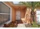 Front entrance featuring a door, window and landscaping at 878 Oviedo Rd, The Villages, FL 32159