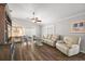 Bright living room featuring a ceiling fan, and a large leather sofa at 878 Oviedo Rd, The Villages, FL 32159