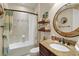 Guest bathroom with tub shower combo, granite countertop vanity, and decorative mirror at 9277 Sw 70Th Loop, Ocala, FL 34481