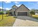 Two-story home with stone accents and a three-car garage at 9277 Sw 70Th Loop, Ocala, FL 34481