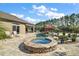 Relaxing hot tub surrounded by stonework and tropical landscaping at 9277 Sw 70Th Loop, Ocala, FL 34481