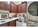 Laundry room with washer, dryer, cabinets, and utility sink at 9277 Sw 70Th Loop, Ocala, FL 34481