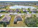 Aerial view of community with lake, fountain, and homes at 9397 Se 124Th Pl, Summerfield, FL 34491